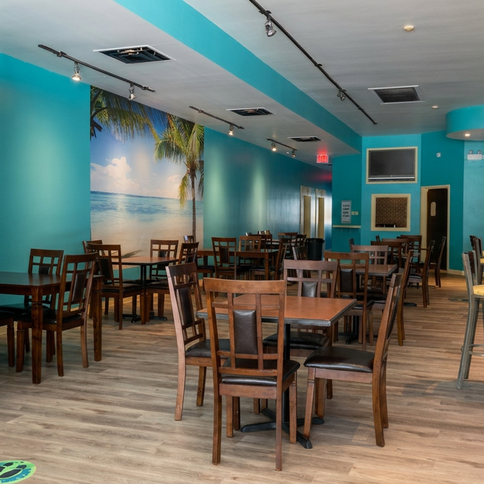 Bright turquoise restaurant dining room with wooden tables, chairs, bar seating, brick accents, and a tropical beach mural.