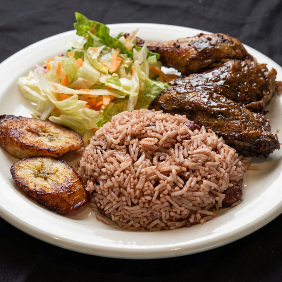 Plate of seasoned rice, grilled meat, fried plantains, and fresh cabbage slaw on a white plate.